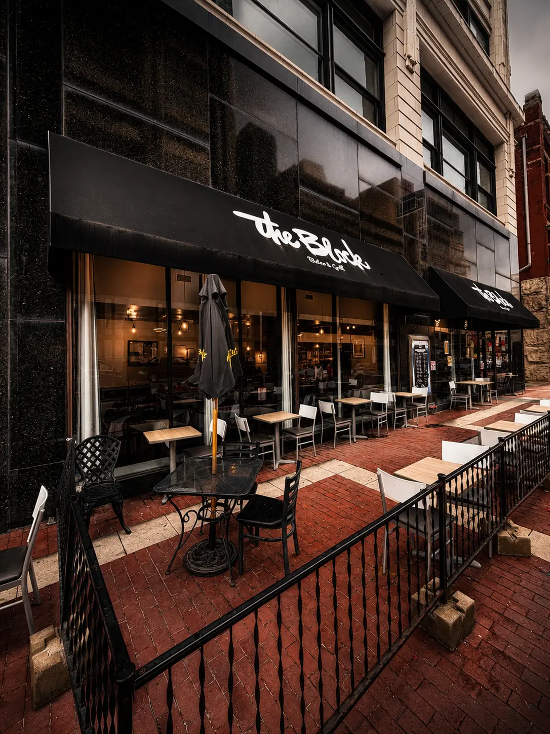 The Block Bistro & Grill storefront with black awnings and sidewalk patio seating in downtown Indianapolis